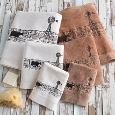 four hand towels with black and white designs on them next to a piece of bread