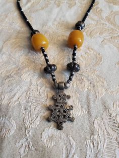 Vintage Ethiopian, Star of David, Cross 18 inch Necklace, Black , Silver Toned and Yellow Bead, Costume Jewelry, Fashion Accessory This is a nice find and very collectible.  Very durable and strong. The pendant measures 1.50 inches tall and .75 inches wide. Check out our shop for monthly specials. We have a variety of items for every taste. Combine several of our items together to save on shipping. If you have any questions please do not hesitate to ask. I will ship outside of the US, just request a quote. Happy Shopping. I will work around the priority mail price. Just send me your zip code and I will get a quote. As shop owners we will do our best to describe any issues or problems with our items. Since we do sell vintage and antiques there may be some flaws. Please check out the picture Black Pendant Jewelry With Large Beads, Black Star Of David Necklace, Spiritual Style, Black Star Of David Spiritual Necklace, Black Star-shaped Spiritual Jewelry, Black Spiritual Necklace With Star Of David, Black Spiritual Star-shaped Jewelry, Handmade Black Star Necklace, Black Bohemian Cross Necklace, Bohemian Black Cross Necklace