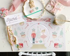 a table topped with plates and napkins covered in pink ribbon next to other items