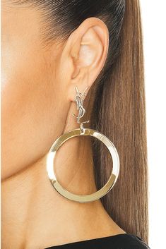 Find SAINT LAURENT Ysl Hoop Earrings In Metallic Gold on Editorialist. Saint Laurent YSL Hoop Earrings in Metallic Gold Gold-tone metal with cassandre logo. Made in Italy. Post-back closure. Measures approx 3.5 dangling. SLAU-WL201. 784142-Y1500-8030. About the designer: SAINT LAURENT has been influencing and revolutionizing the fashion industry since the debut of its iconic ‘Rive Gauche’ collection in 1966 - the couture house was the first to create a ready-to-wear capsule. The sleek, precisely Yves Saint Laurent Earrings, Ysl Earrings, Saint Laurent Earrings, Ysl Handbags, Biker Jackets, Anthony Vaccarello, Link Earrings, The Fashion Industry, Rive Gauche