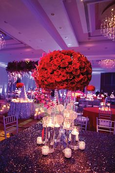 a table with candles and flowers in vases on it at a banquet or wedding