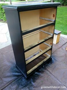 an empty cabinet sitting on top of a patio