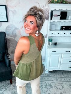 This effortlessly cool tank was made for summer nights that turn into mornings. In an olive green knit blend, it features spaghetti straps, a raw-edge hem and neckline studded with metal embellishments that catch the light. Throw it on over your favorite bralette or camisole and head out for a night of adventure that lasts until dawn. Whether you're dancing on the beach or stargazing with friends, this breezy top moves with you while its loose, laid-back fit keeps you comfortable into the wee ho Green Tops With Built-in Bra For Spring, Trendy Green Tops With Tank Straps, Spring Knit Tank Top With Spaghetti Straps, Green Tank Strap Camisole For Spring, Cotton Tank Top For Night Out, Green Camisole With Tank Straps For Spring, Green Cotton Camisole With Tank Straps, Trendy Green Camisole Tank Top, Stretchy Olive Summer Tops