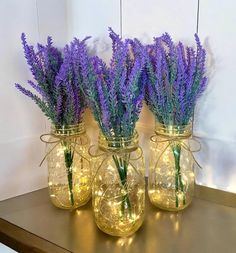 three mason jars with lavender flowers in them