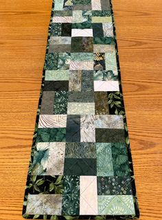 a table runner made out of patchwork fabric