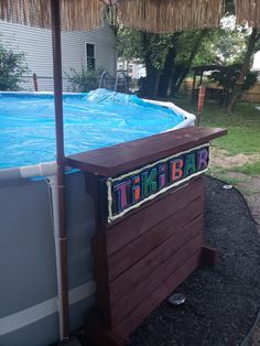 an above ground pool with a tiki bar in the middle