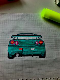 a drawing of a car is shown on a piece of paper with crayons