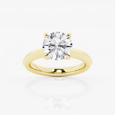 a yellow gold engagement ring with a round brilliant cut diamond in the center, on a white background