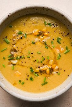 a white bowl filled with soup on top of a table