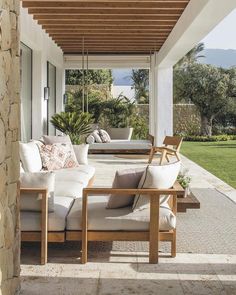 an outdoor living area with couches and chairs