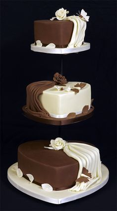 three tiered cake with white and chocolate frosting