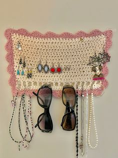 a pair of black shoes sitting on top of a table next to a crocheted wall hanging