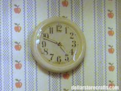 an alarm clock sitting on top of a wall next to a striped wallpaper background