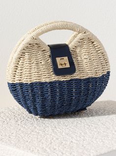 Add a classic touch to your outfit this summer with Shiraleah's Giorgia Cross Body Bag. Made from woven paper straw and durable PU, this bag is the perfect blend of today's trendiest accessories. The cutout top handle and detachable, adjustable cross-body strap allow for versatility in your style, and the secure turn-lock closure keeps all your items safe and secure. Pair with other items from Shiraleah's American Summer collection to complete your look! Chic Woven Top Handle Beach Bag, Chic Beach Bags With Bamboo Handle, Chic Shoulder Bag With Round Handle For Beach, Chic Beach Shoulder Bag With Round Handle, Chic Woven Beach Bag With Round Handle, Chic Crochet Bag With Round Handle For Beach, Trendy Straw Bag With Round Handle For Vacation, Chic Open Weave Top Handle Shoulder Bag, Chic Crochet Beach Bag With Round Handle