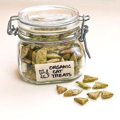 a glass jar filled with green cat treats