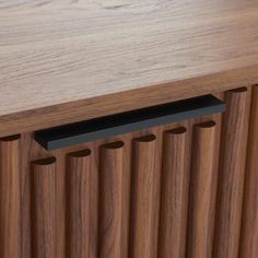 a close up view of a wooden cabinet with metal bars on the bottom and sides