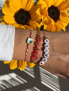 Three Bracelets for March with different central charms that will protect you from the spring's sun. The first bracelet has a tiny evil eye in rectangular shape, the middle bracelet a raw of tiny flowers and the last one is a bracelet with tiny letters that write ''LOVE MARCH'' and completes this unique set. You can wear them together or separetely as well. Find them only at Christina Christi Store. 👉 My Mens Bracelets Collection: https://etsy.me/2UunKla 👉 Express Shipping: https://etsy.me/3ik Handmade Red Bracelets For Everyday, Red Personalized Spiritual Bracelets, Personalized Red Spiritual Bracelets, Personalized Spiritual Red Bracelets, White Beaded Friendship Bracelets With Charms, Red Bohemian Bracelets With Letter Beads, Bohemian Red Bracelets With Letter Beads, Handmade White Good Luck Bracelets, Red Beaded Bracelets With Charms