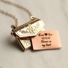 This engraved personalised envelope locket comes with a personalized letter inside, engraved with any message you choose! Your message will be beautifully engraved on a solid copper letter in our Edinburgh studio, and can be personalised in a choice of five beautiful fonts. Please check our photos for a Font Guide. The locket is made from gold plated brass. The front and back of the locket are decorated with a charming botanical leaf design. The locket measures just one inch (2.5cm) across, and Engrave Necklace, Jewelry Engraving, Envelope Necklace, Gold Envelope, Font Guide, Engraved Locket, Gold Locket Necklace, Gold Envelopes, Personalized Bridesmaid Gifts