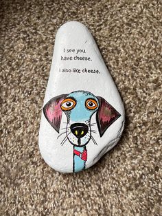 a painted rock with a dog's face on it