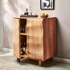 a wooden cabinet with an open door and shelves on the side, in front of a wall