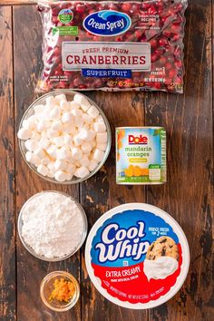 ingredients needed to make cranberry cookies laid out on a wooden table including cream cheese, sugar and jelly