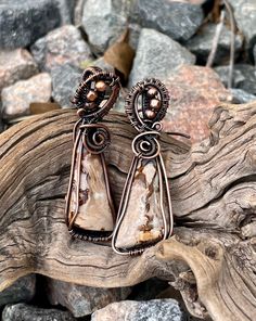 These exquisite Indonesian Petrified Wood Earrings blend ancient natural beauty with contemporary design. Crafted with petrified wood from Indonesia and framed in copper, these earrings offer a unique and stylish touch to your jewelry collection. Designed with hypoallergenic ear wires, they are perfect for those with sensitive skin. Artisan Copper Wire Drop Earrings, Copper Wire Dangle Earrings As Gift, Copper Wire Drop Earrings With Matching Set, Hypoallergenic Adjustable Wrap Earrings For Gift, Unique Hypoallergenic Drop Earrings, Unique Hypoallergenic Adjustable Earrings, Nickel-free Copper Wire Earrings As Gift, Nickel Free Copper Wire Earrings As A Gift, Unique Nickel-free Copper Wire Earrings