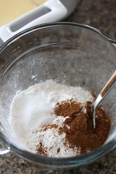 a glass bowl filled with brown and white ingredients