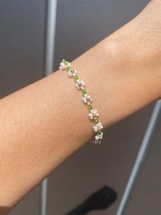 White & Green Daisy Beaded Bracelets Green Flower Bead Bracelet, Green Flower Bracelet, White Beaded Bracelets With Flower Charm For Spring, Spring White Beaded Bracelets With Flower Charm, Spring Beaded White Pearl Bracelet, White Dainty Flower Shaped Beaded Bracelets, White Spring Jewelry With Tiny Beads, Spring White Jewelry With Tiny Beads, Adjustable White Pearl Bracelet For Spring