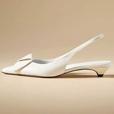 Chic and versatile, these white slingback kitten heel pumps exude elegance with a pointy toe design. A perfect blend of style and sophistication for any occasion. Color: White Heel Type: Kitten heel Heel height: 1.18" / 30 mm approx Product measurements were taken using size 8. Please note that measurements may vary by size. Toe: Pointed toe Elastic slingback design Handcrafted US sizing. Fits true to size. White Low Heel Slingback Sandals With Heel Strap, White Slingback Sandals With Low Heel, White Elegant Low Heel Slingback Sandals, White Slingback Pumps With Sculpted Heel And Pointed Toe, White Slingback Pumps With Sculpted High Heel, Elegant White Slingback Pumps For Formal Occasions, Classic White Ankle Strap Slingback Sandals, White Wedding Flats, White Low Heel Slingback Pumps For Evening