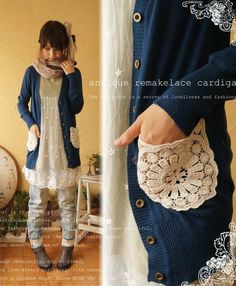 the woman is wearing a blue cardigan and holding a white doily in her hand