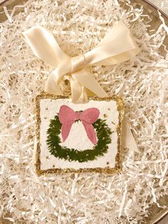 a christmas ornament with a pink bow on it