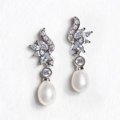 two pairs of pearl and diamond earrings on white background with clippings to the side