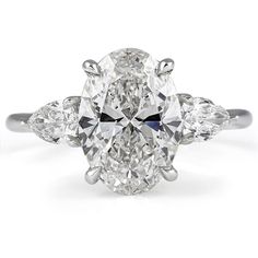 an oval cut diamond ring with three pear shaped diamonds