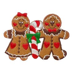 two gingerbread cookies with candy canes on them