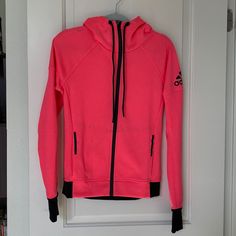 Nwot Adidas Track Hoodie Jacket Xs. Gorgeous Bright Coral Pink Color With Black Adidas Logo And Trim And Zipper. Jacket Features Thumb Holes. Functional Winter Hooded Jacket For Workout, Functional Winter Hooded Workout Jacket, Functional Winter Workout Hooded Jacket, Winter Sportswear Hooded Workout Jacket, Winter Athleisure Fleece Jacket With Double-lined Hood, Pink Long Sleeve Hoodie For Outdoor, Winter Workout Track Jacket, Sporty Fleece Jacket With Drawstring Hood For Fall, Sporty Long Sleeve Fleece Jacket For Winter