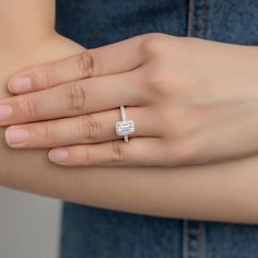 a woman's hand with a diamond ring on it