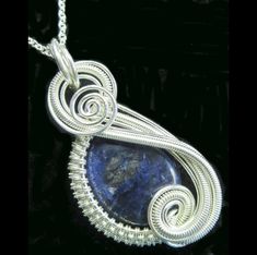 "This beautiful wire-wrapped pendant was made in sculpted Sterling silver wire, draped in lovely hand-woven accents, as it cradles a deep-blue sodalite stone. This gorgeous piece comes suspended on your choice of chain that closes with a lobster-claw clasp. The entire pendant measures approximately 41x22x7mm (1.6\" x 0.9\" x 0.3\") and is sure to attract compliments wherever you choose to wear it. *American quarter (coin) is shown for scale and will not be included with the jewelry!" Unique Silver-plated Wire-wrapped Jewelry, Unique Silver Plated Wire-wrapped Jewelry, Unique Silver Plated Wire Wrapped Jewelry, Artisan Wire Wrapped Silver Plated Jewelry, Hand Wrapped Silver Wire Jewelry, Artisan Wire Wrapped Jewelry In Silver Plated Wire, Unique Silver-plated Wire Wrapped Jewelry, Silver Freeform Wire Wrapped Jewelry, Blue Spiral Sterling Silver Jewelry