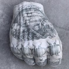 a hand that has some tattoos on it