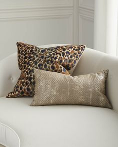 two leopard print pillows on a white couch