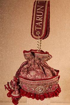 Maroon potli bag all over floral jaal pattern, poth local, thread, sequin, beads, glass beads embroidery, pom-pom tassel details and attached logo thread embroidered drop handle. - Aza Fashions Glass Beads Embroidery, Ikat Bag, Potli Bag, Sewing Easy Diy, Beads Embroidery, Potli Bags, Tarun Tahiliani, Handbags Online, Online Bags