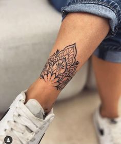 a woman's foot with a tattoo on it