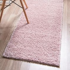 a pink rug on the floor in a living room