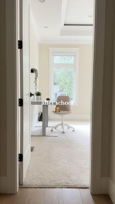 an open door leading to a white room with a chair and desk in the corner