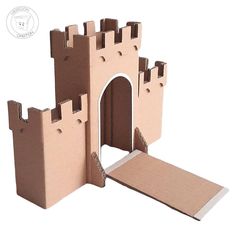 a cardboard castle made to look like it's built into the ground with a ramp