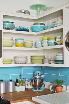 the shelves in the kitchen are filled with dishes