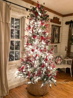 a white christmas tree with red and green decorations