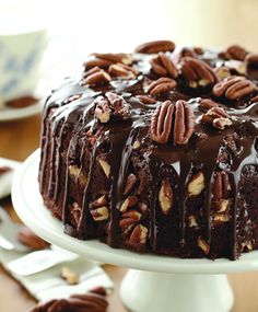 a chocolate cake with pecans on top