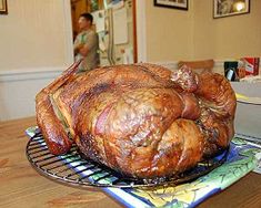 a large turkey sitting on top of a metal rack