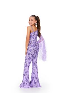 The Ashley Lauren Kids 8268 Girls Beaded Pageant Jumpsuit is a must-have for any fashion-forward young lady. Adorned with intricate beadwork and featuring dramatic feather bell sleeves, this jumpsuit will make her feel like a true fashionista. Perfect for pageants or any special occasion, it's both stylish and fun. This one shoulder kids jumpsuit features an intricate bead pattern throughout. The look is complete with a bell-sleeve scattered with feathers. One Shoulder Jumpsuit Bell Sleeve with Jumpsuit For Kids, One Shoulder Jumpsuit, Long Jumpsuits, Designer Gowns, Pink Candy, Bell Sleeves, Beading Patterns, Evening Gowns, Lilac