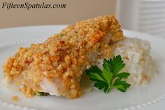 a white plate topped with chicken and rice covered in parmesan crumbs